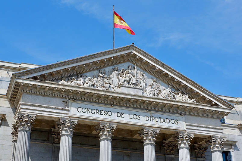 Classical building of Spanish parliament in centre of Madrid, Spain. Deputy congress with national flag on top